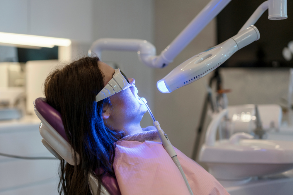 a woman is getting dental treatment.