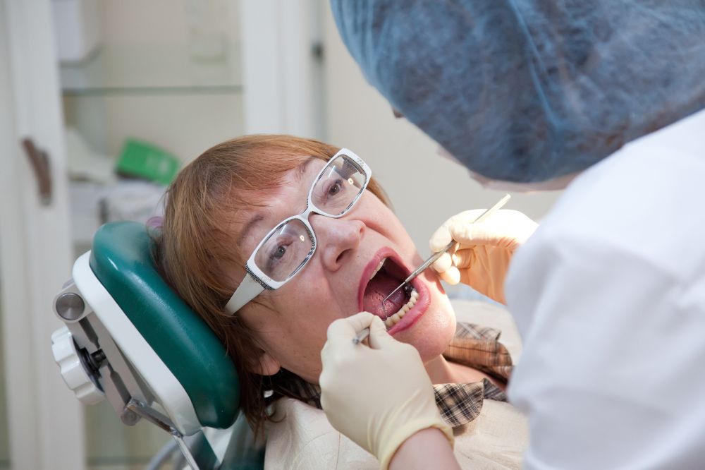 a woman is getting dental treatment.