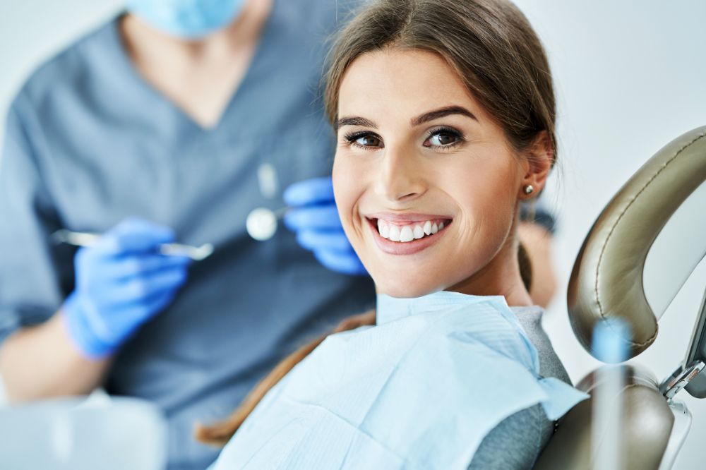 a woman is getting dental treatment.